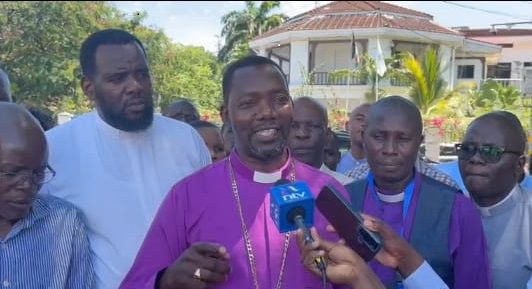 Community leaders, including a bishop, speak to the media about local development initiatives in the.