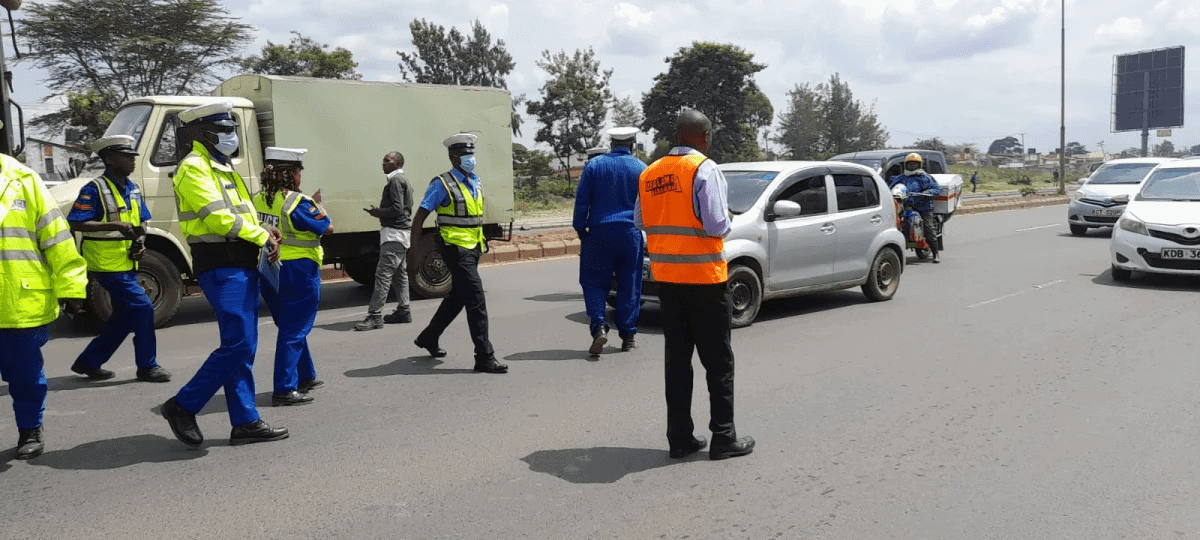 Traffic police officers directing vehicles and ensuring road safety in Kenya.