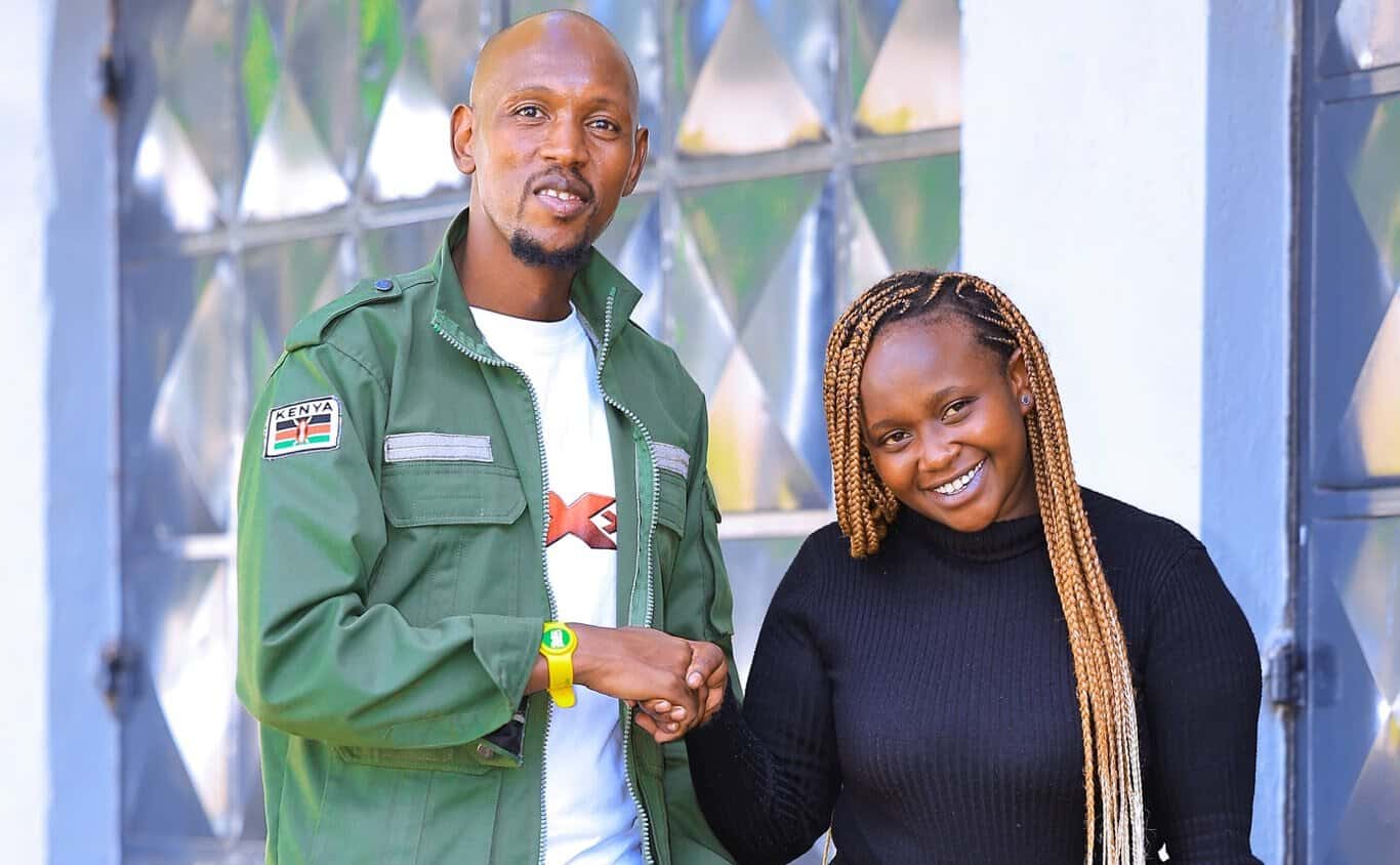 Man and woman shaking hands at Kwetuu Collections event.