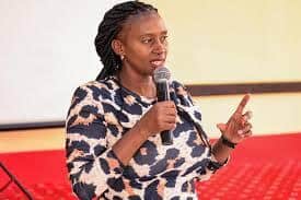 Empowered woman speaking at KWETU NEWS event, engaging audience with impactful presentation.