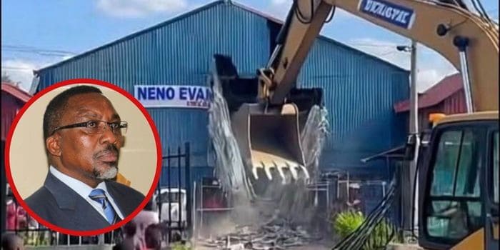 Excavator demolishing concrete at construction site in Kenya.