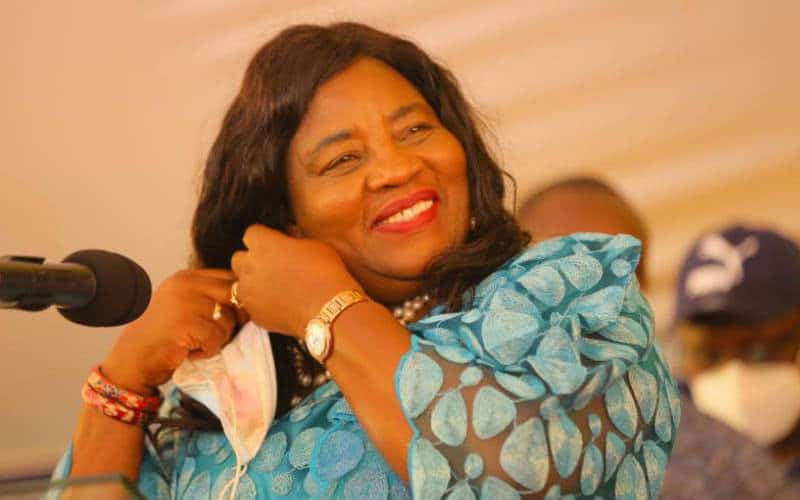 Empowered woman smiling confidently at KWETU NEWS event, showcasing leadership and community engagem.