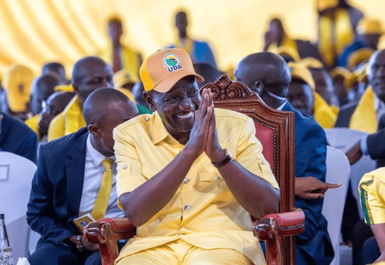 Celebrating leadership at KWETU NEWS event with joyful attendees in yellow attire.