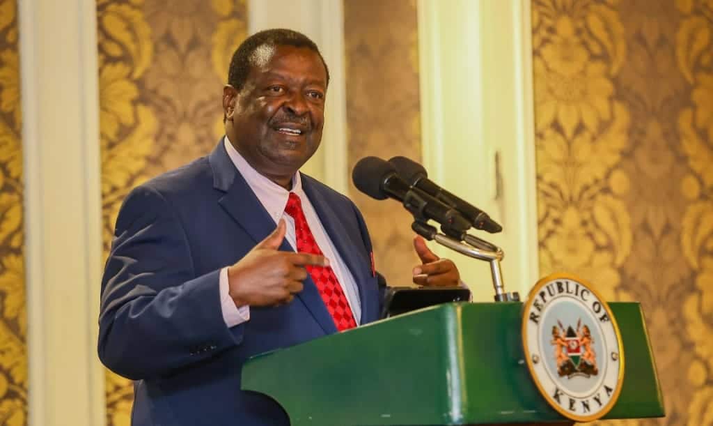 Kenyan official delivering speech at a formal event, emphasizing governance and leadership.