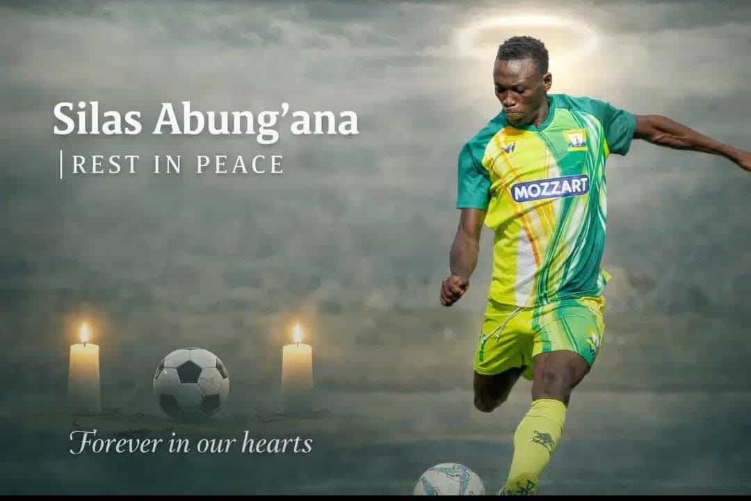A woman in a green and yellow soccer uniform playing football on a foggy field with candles in the b.