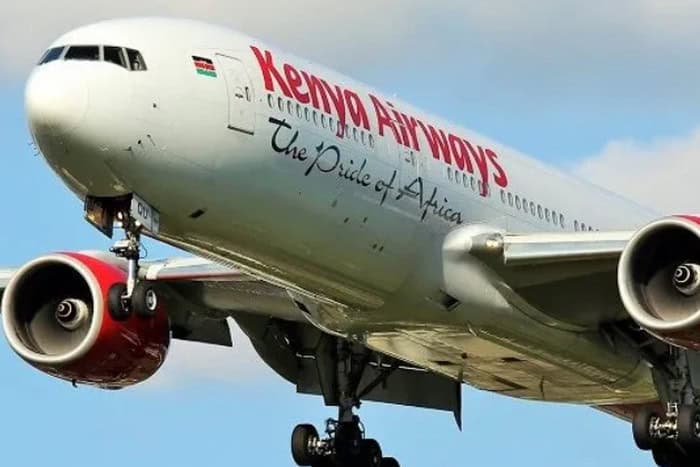 Kenya Airways commercial airplane in flight with clear sky background.