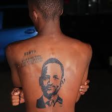 A woman with a large portrait tattoo of Barack Obama on her back.