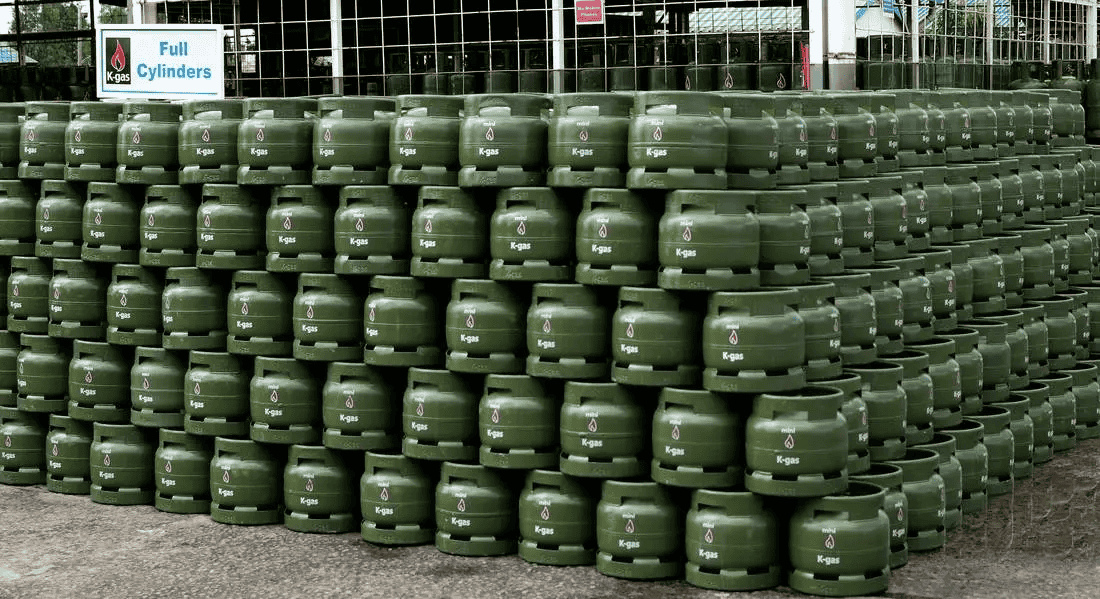 Gas cylinders stacked outdoors at a storage facility.