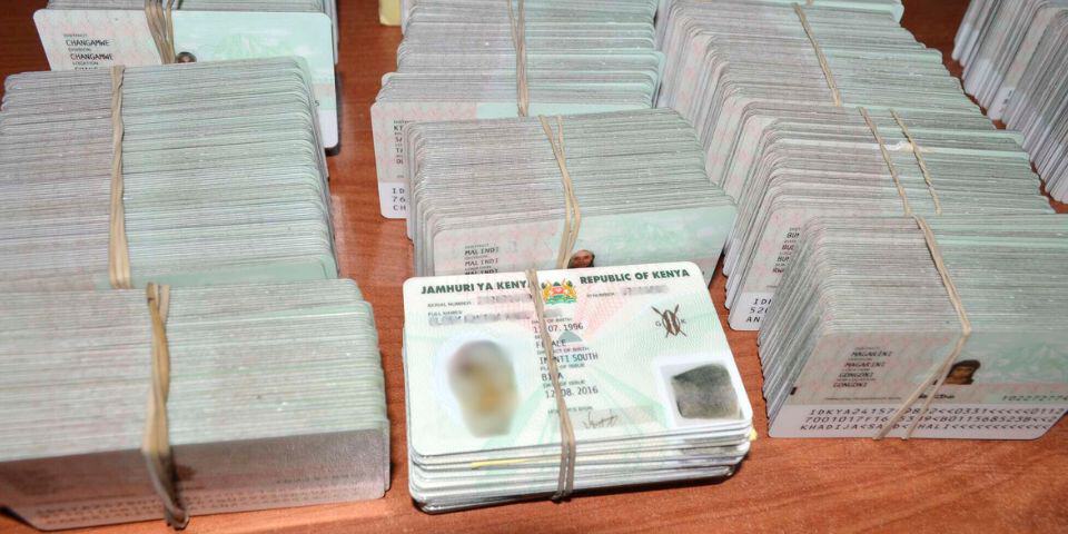 Close-up of stacked Kenyan election ballots with security features.
