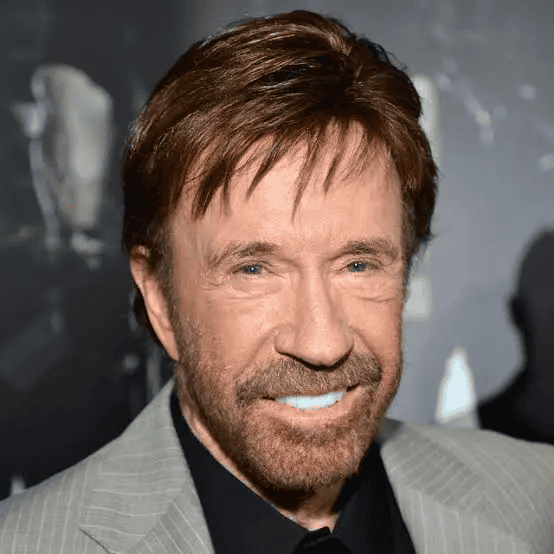 A man with brown hair and beard smiling at an event.