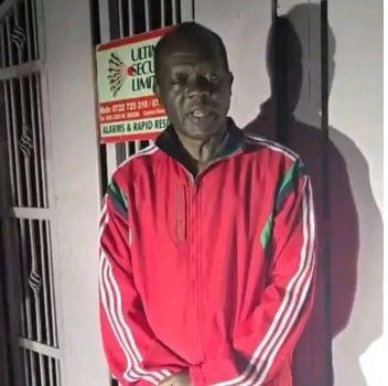 Community leader wearing a red jacket at Kwetuu Collections event.